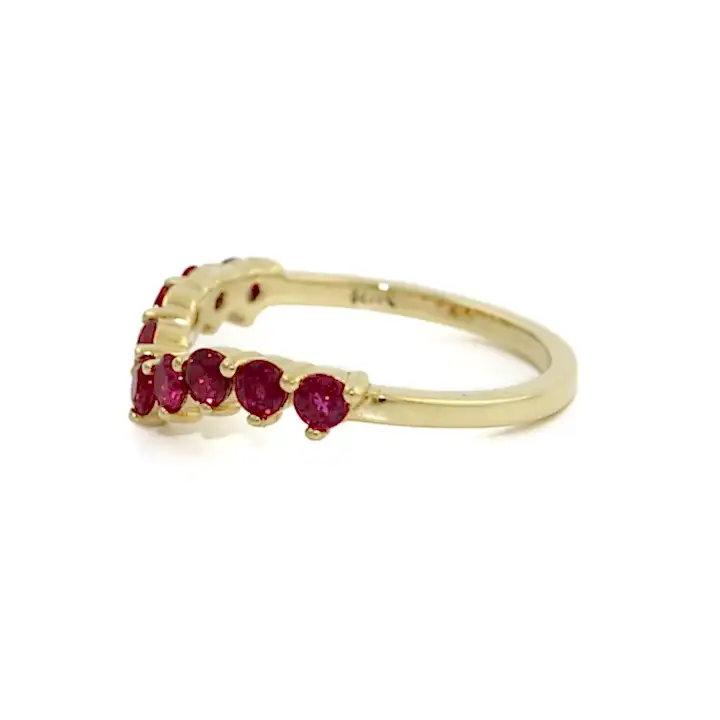 A gorgeous band comprised of 9 round cut rubies, aligned in a chic tiara shaped setting. Set in 14k yellow gold, the vibrant rubies truly pop. Each Ruby is set with a prong bezel allowing you to see each stone in full dimension. All together the elements work beautifully as the crowning jewel band to your existing set, or a modern standalone piece. This isn't your run of the mill stacking band!   Made by Kingdom Jewelry using Rubies and 14k Yellow Gold